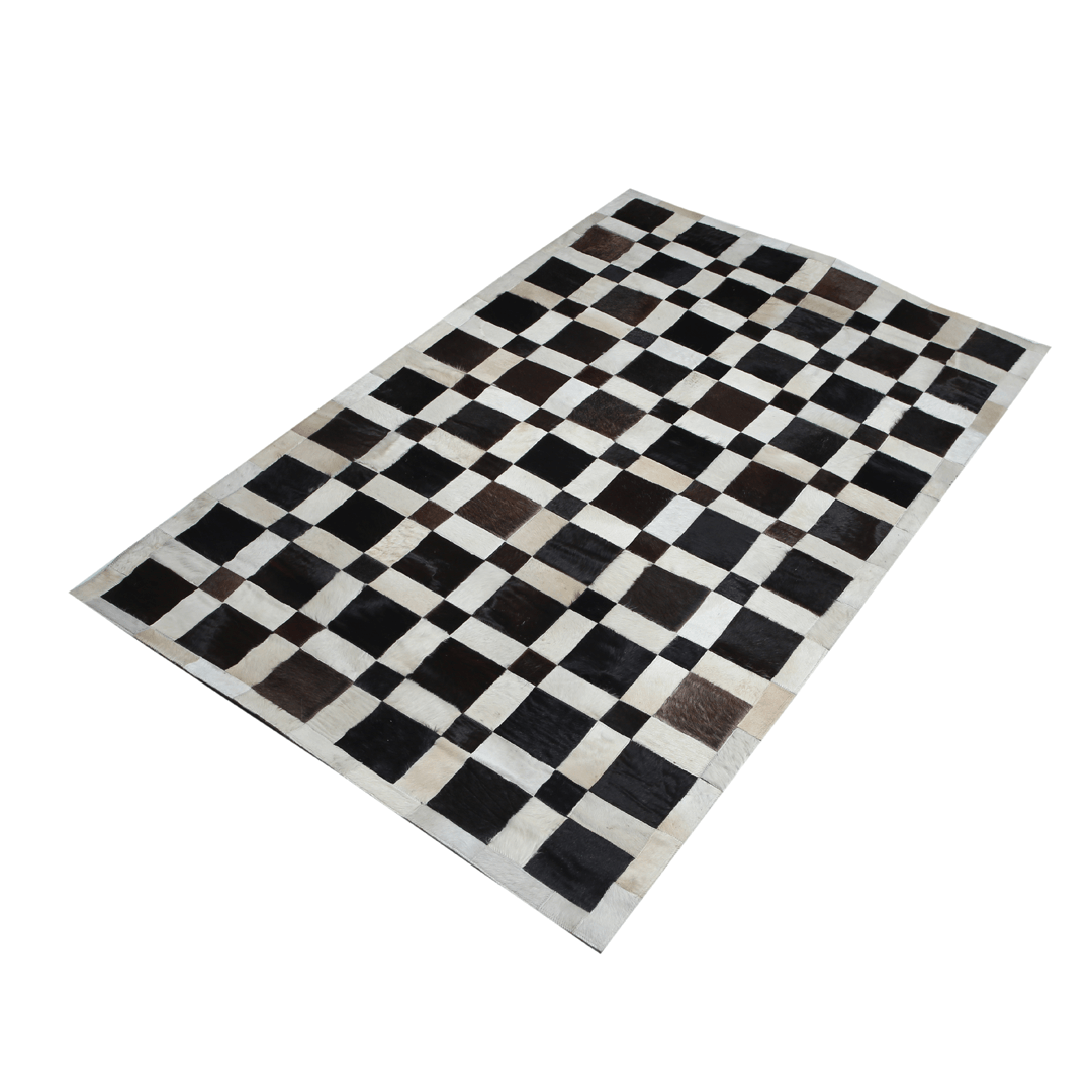 Handmade cowhide leather rug featuring a unique square patchwork design, showcasing natural textures and colors.