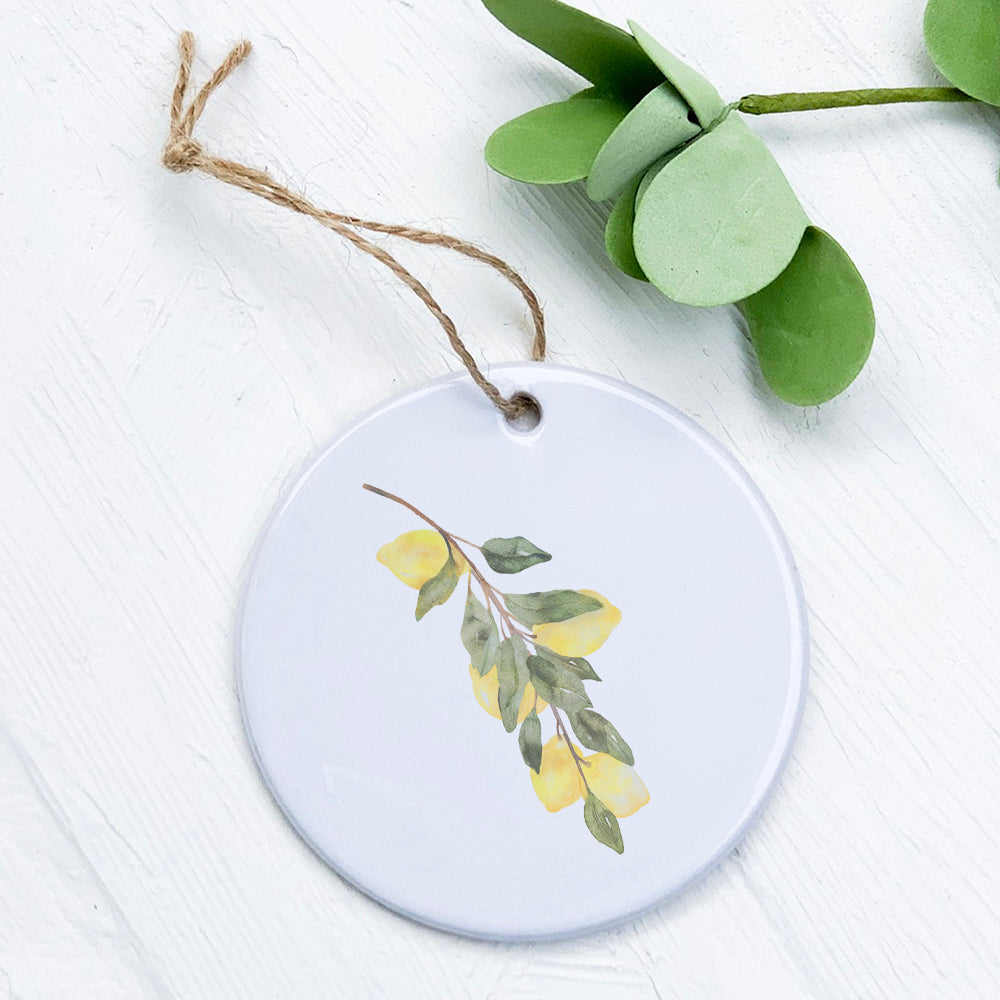 Lemon Branch Ornament made of high-quality porcelain with vibrant design, measuring 2.75 inches in diameter.