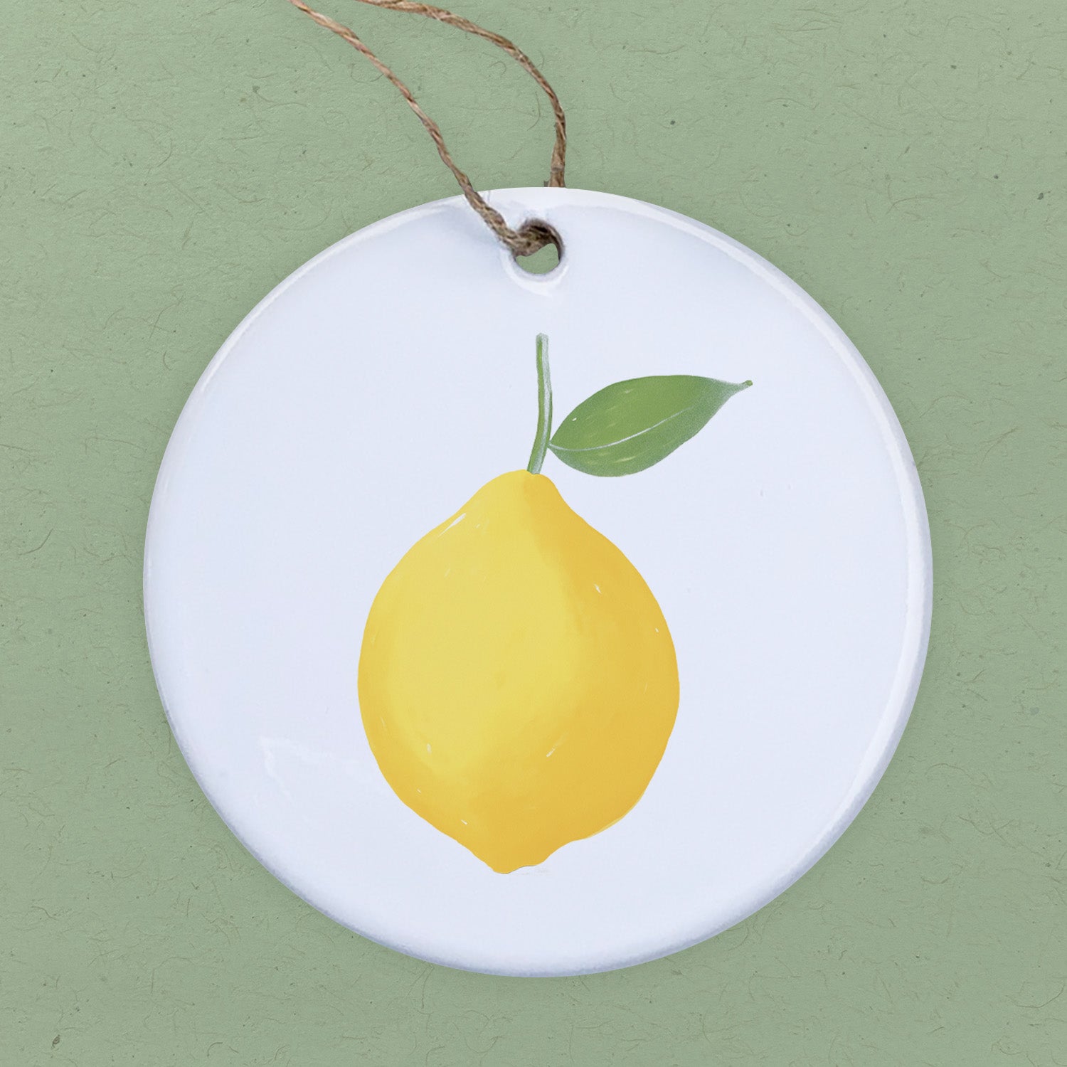 A beautifully crafted lemon ornament made of high-quality porcelain, featuring a vibrant design and smooth gloss finish, perfect for home decor or gifts.