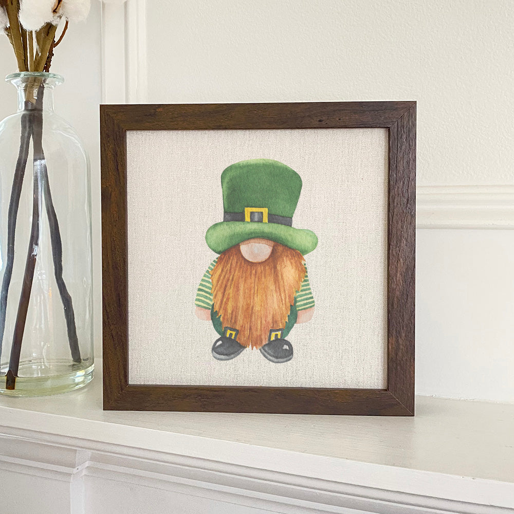 Leprechaun framed sign with a wood frame, eco-friendly printing, and a linen-look background, displayed on a shelf.