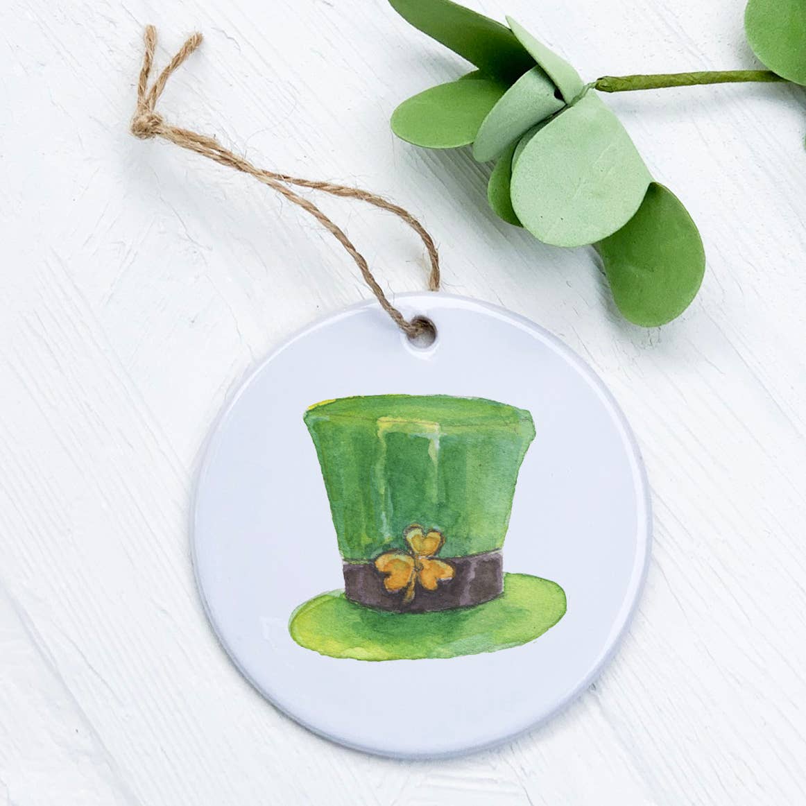 A vibrant porcelain ornament shaped like a leprechaun hat, featuring intricate designs and a smooth gloss finish.