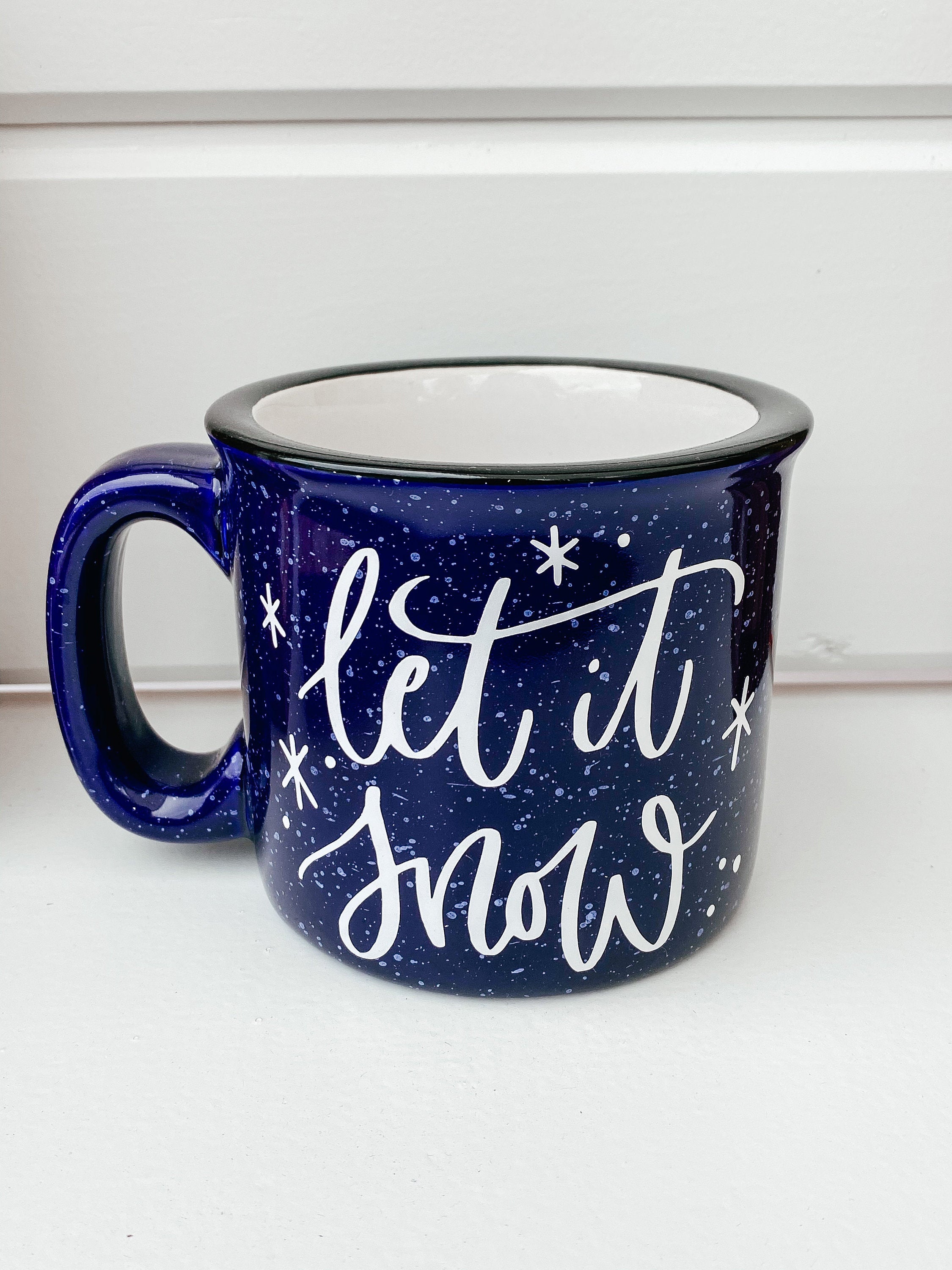 Let It Snow Campfire Mug with a winter-themed design, perfect for cozy beverages.