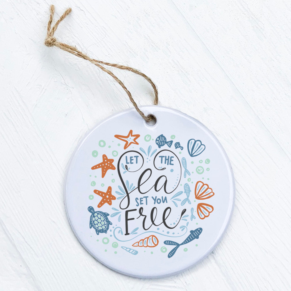 A beautifully crafted porcelain ornament featuring the design 'Let the Sea Set You Free', showcasing vibrant colors and a smooth finish.