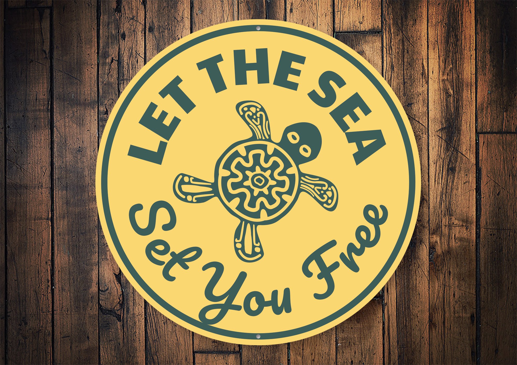 A decorative 'Let the Sea Set You Free' sign made of aluminum, featuring beach-themed design elements, perfect for coastal decor.