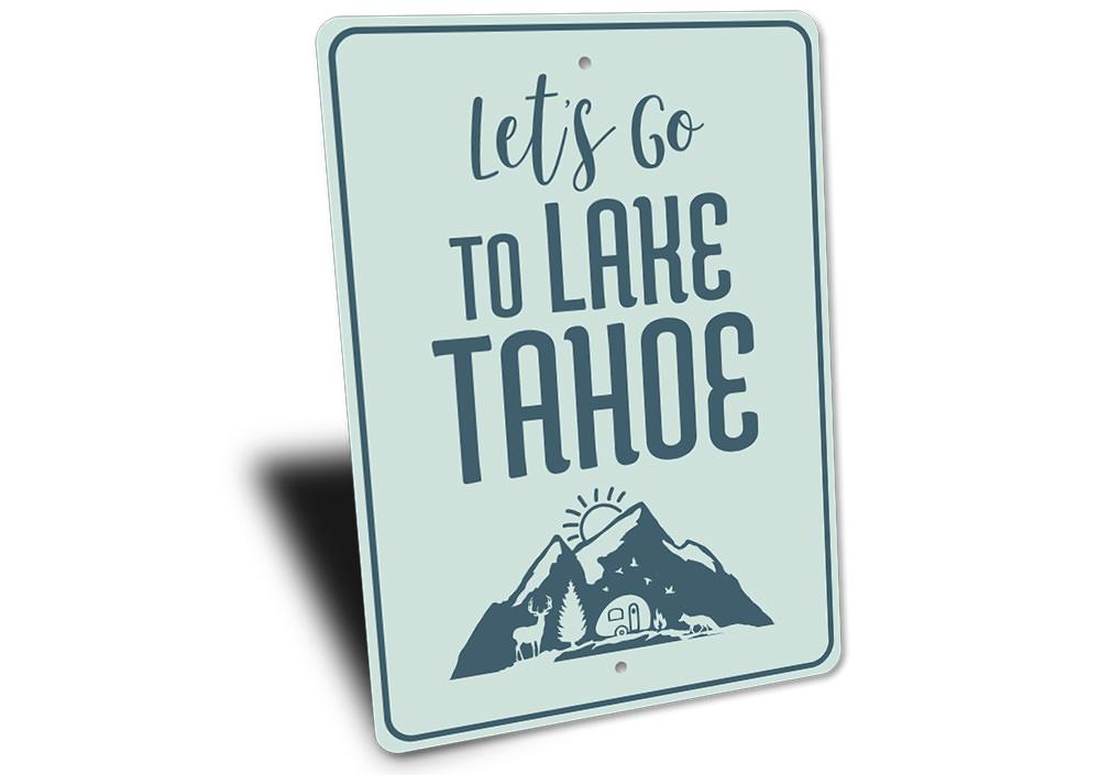 A decorative metal sign featuring 'Let's Go to Lake Tahoe' text, showcasing a beautiful lake scene, perfect for lakehouse decor.