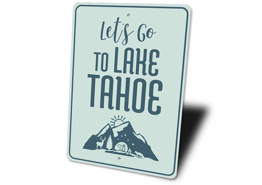 A decorative metal sign featuring 'Let's Go to Lake Tahoe' text, showcasing a beautiful lake scene, perfect for lakehouse decor.