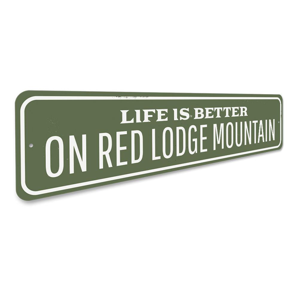 A decorative metal sign reading 'Life is Better at the Lodge', showcasing a rustic design perfect for lakehouses.