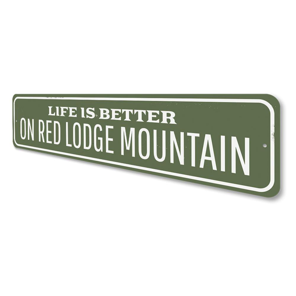 A decorative metal sign reading 'Life is Better at the Lodge', showcasing a rustic design perfect for lakehouses.