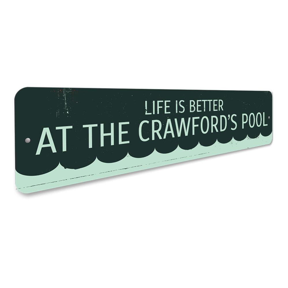 A decorative metal sign that reads 'Life is Better at the Pool', showcasing vibrant colors and a stylish design, perfect for poolside decor.