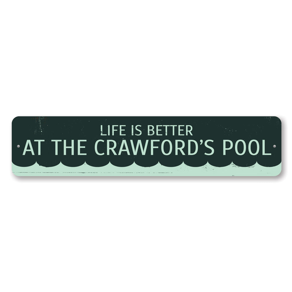 A decorative metal sign that reads 'Life is Better at the Pool', showcasing vibrant colors and a stylish design, perfect for poolside decor.