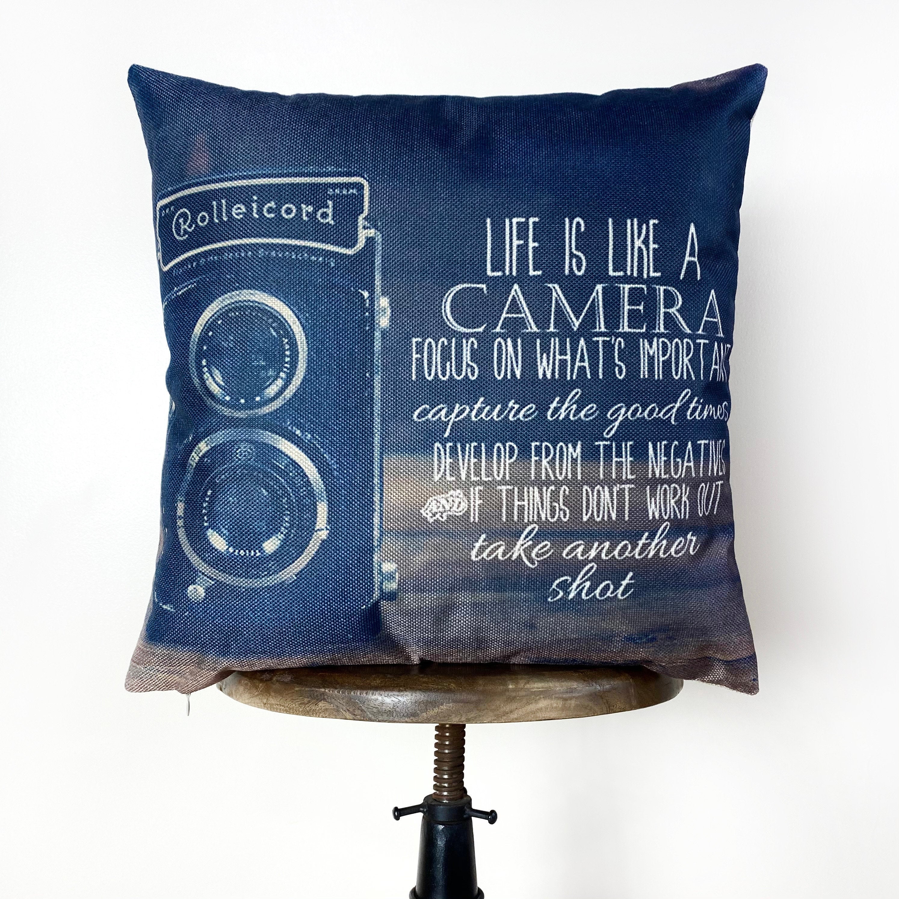 Antique camera pillow cover featuring a motivational quote, perfect for photography lovers and home decor.