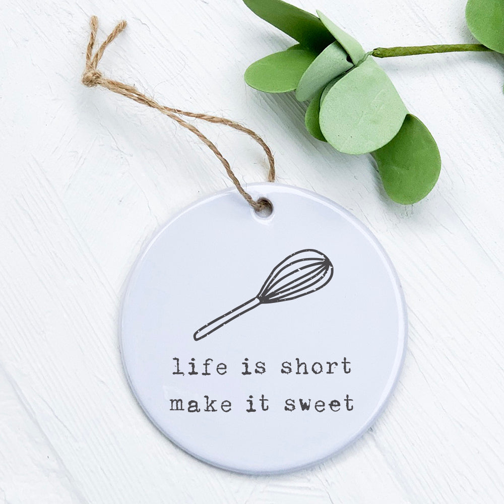 A beautifully crafted porcelain ornament featuring the phrase 'Life is Short' with a whisk design, perfect for home decor or gifting.