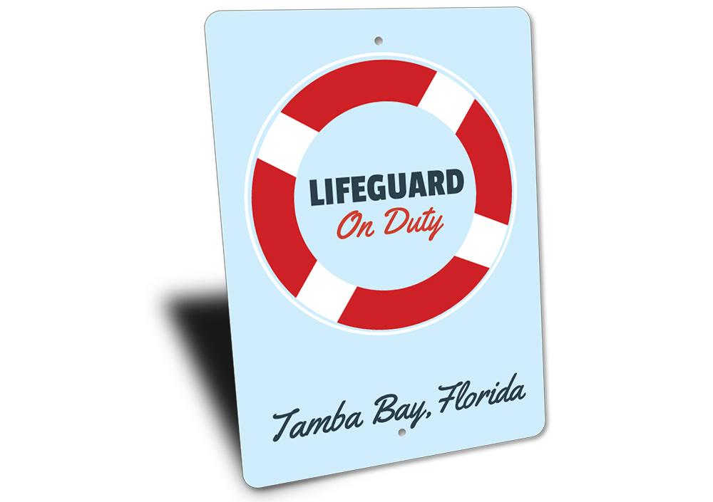 A decorative Lifeguard Sign made of high-quality aluminum, featuring customizable text, perfect for beach houses and coastal decor.