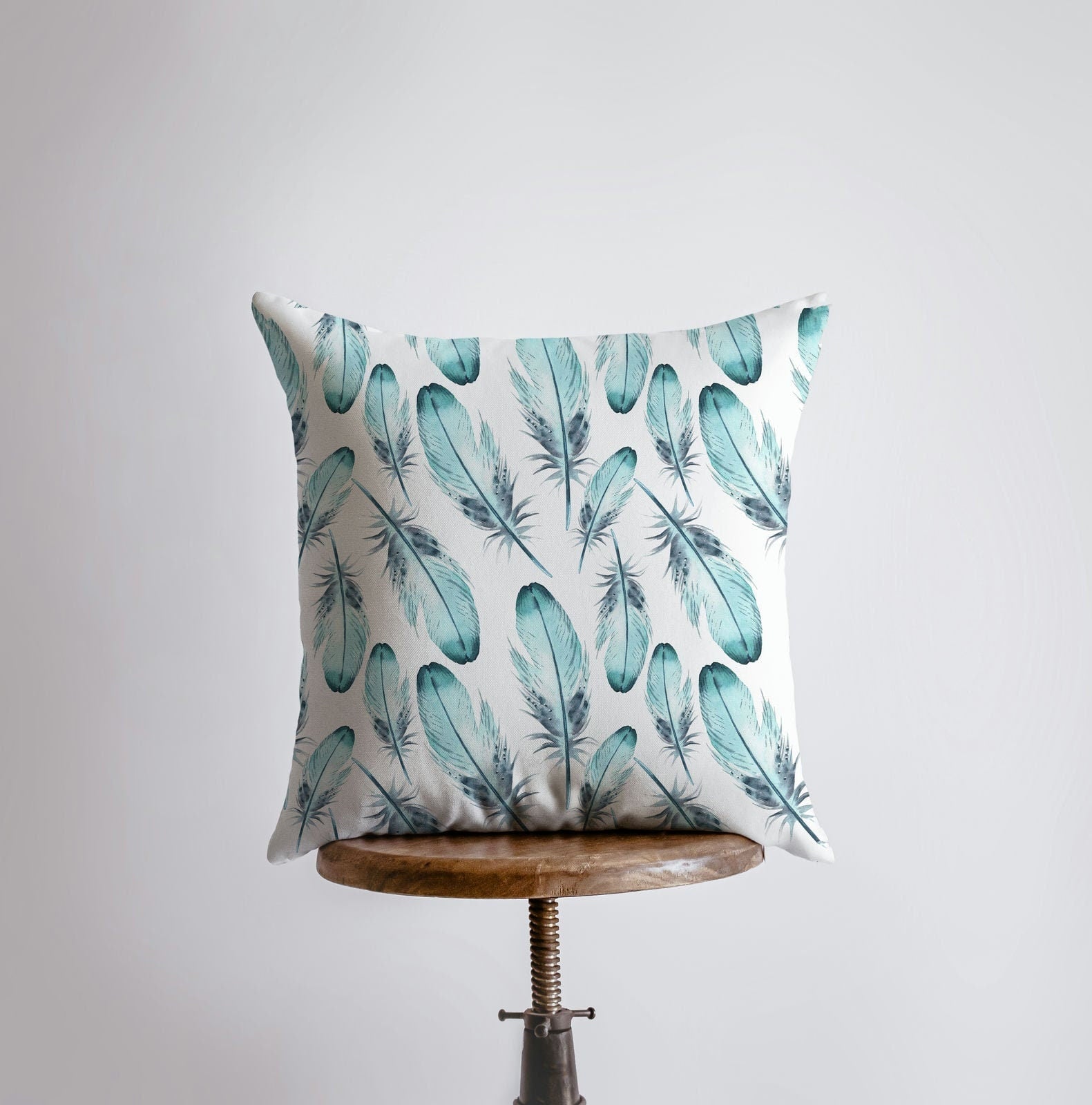 Light Blue Feathers Pillow Cover featuring a blue feather pattern on the front and a double-sided print on the back, handcrafted in America.