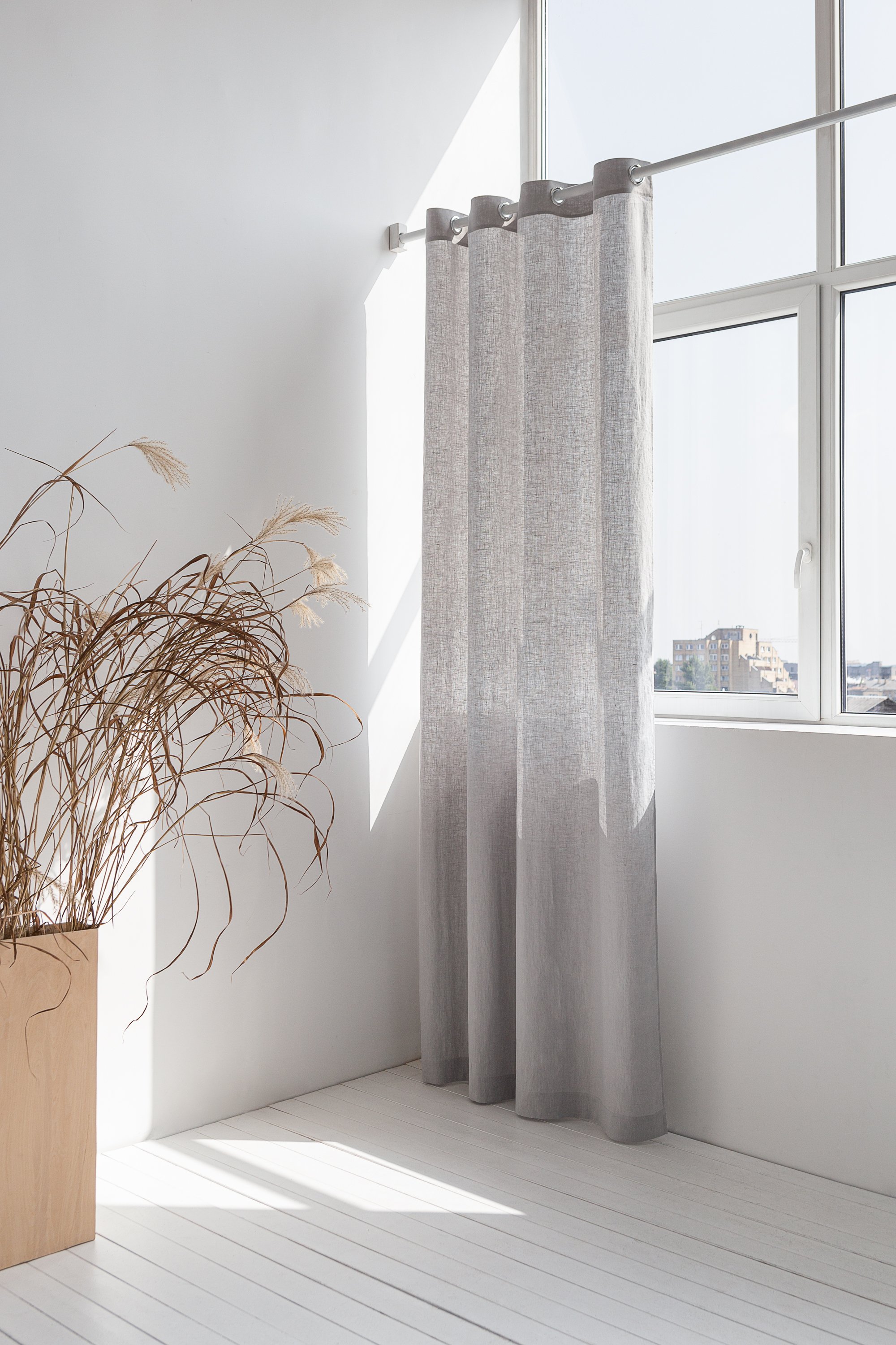 Light grey linen curtain with grommets, showcasing elegant draping and natural texture.