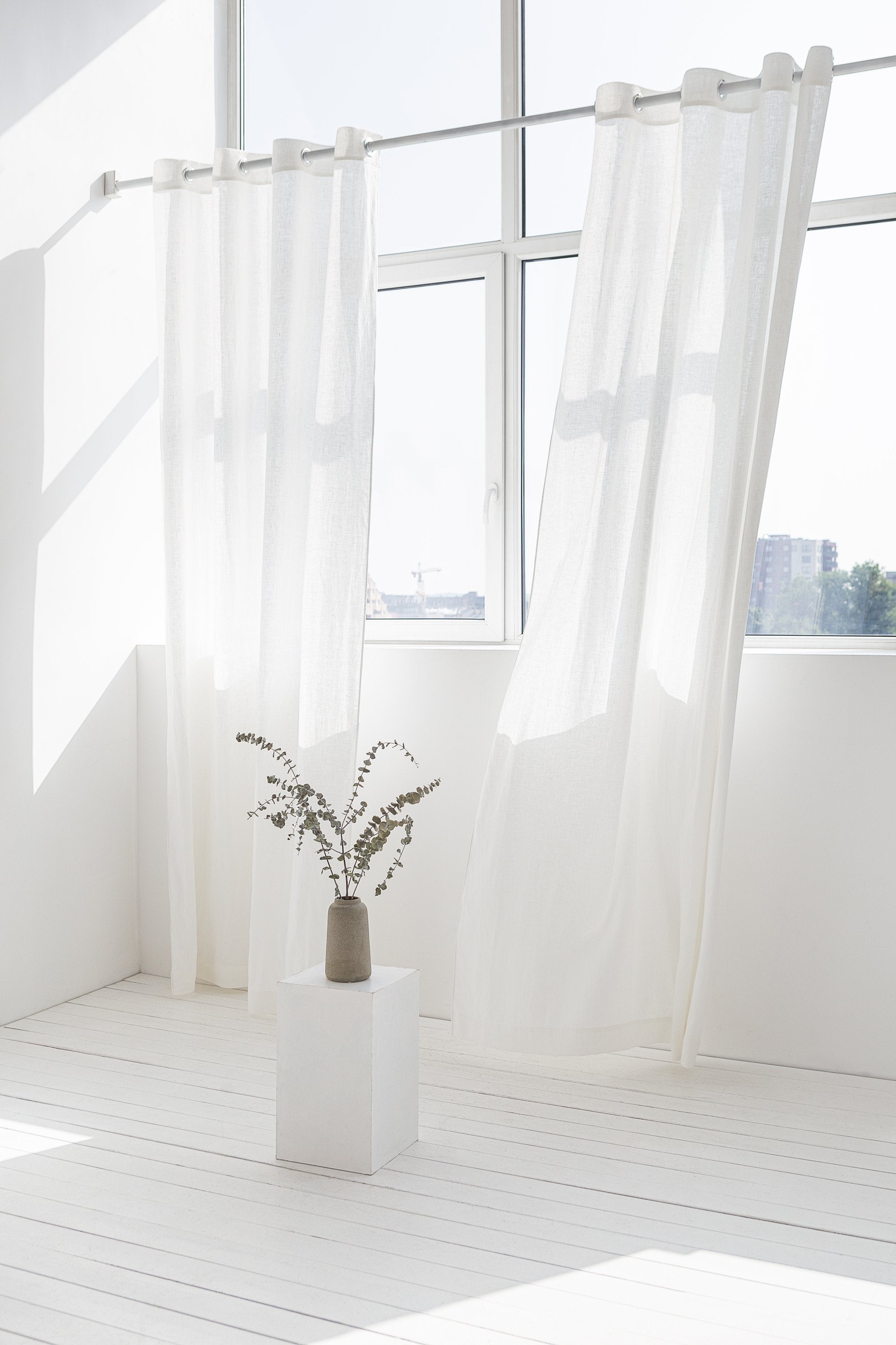 Light grey linen curtain with grommets, showcasing elegant draping and natural texture.