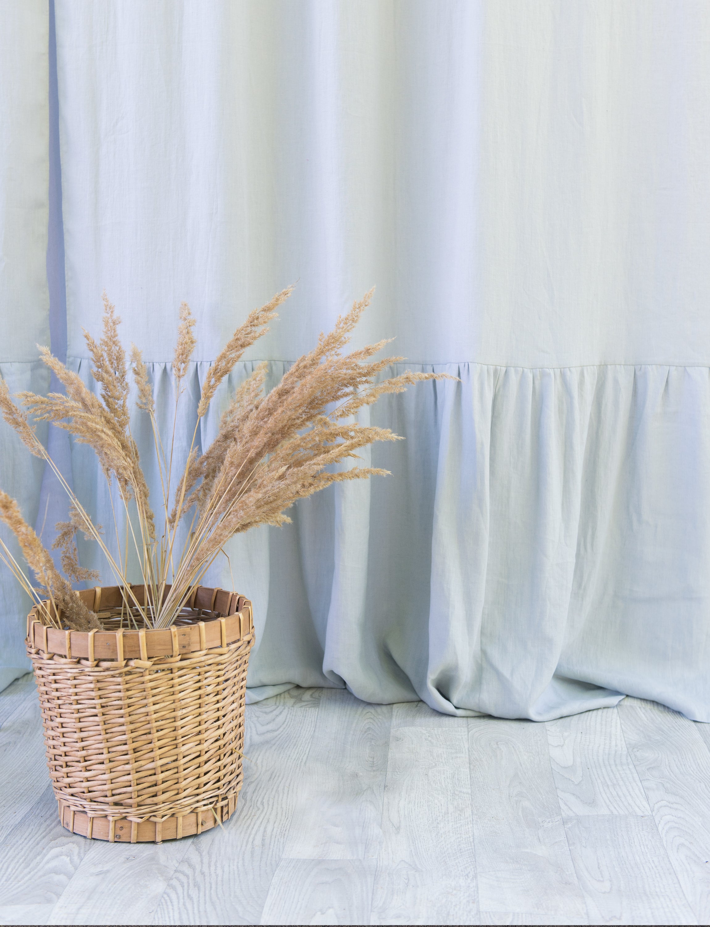 Light Grey linen curtain with ruffles and rod pocket, elegantly draped to showcase its texture and design.