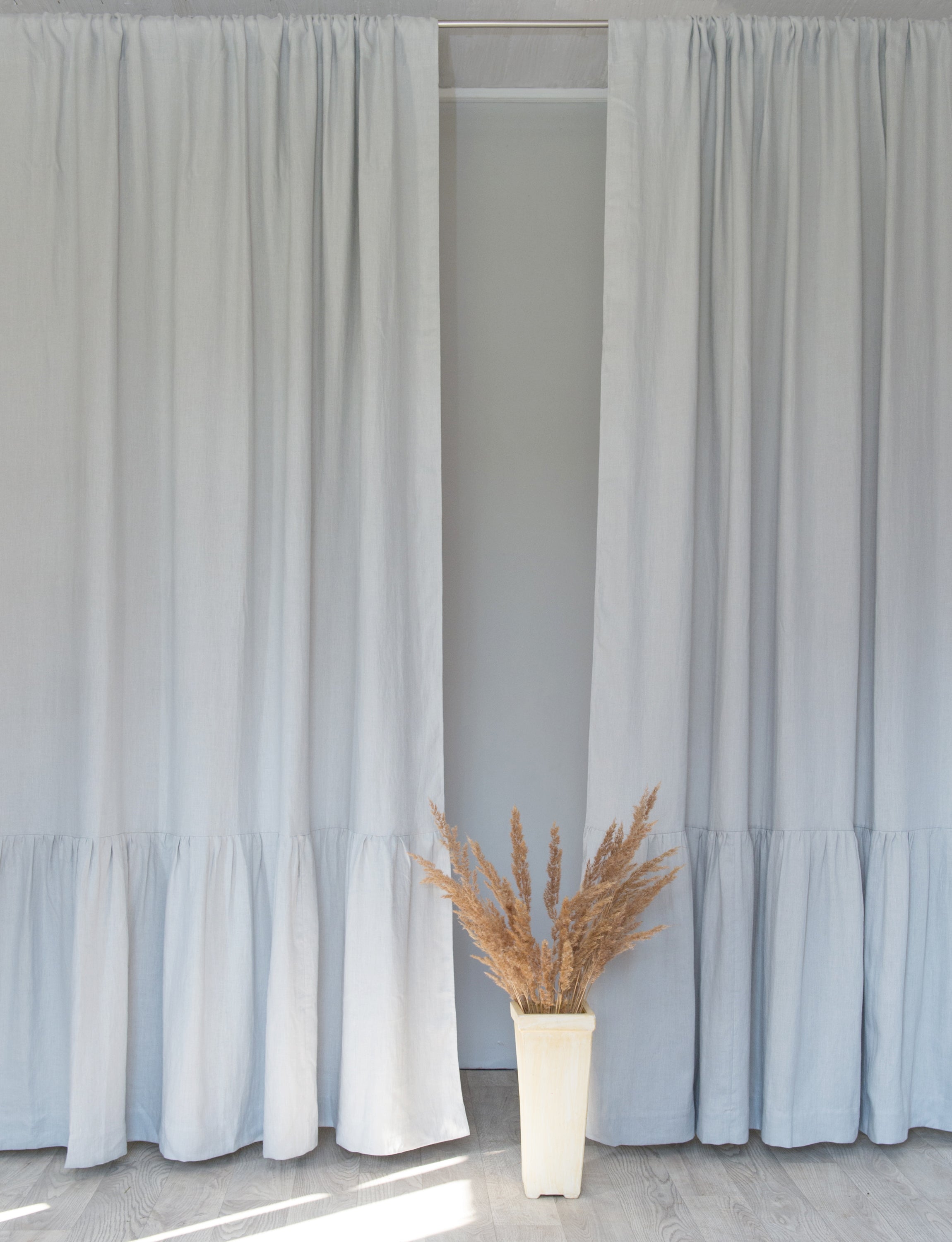 Light Grey linen curtain with ruffles and rod pocket, elegantly draped to showcase its texture and design.