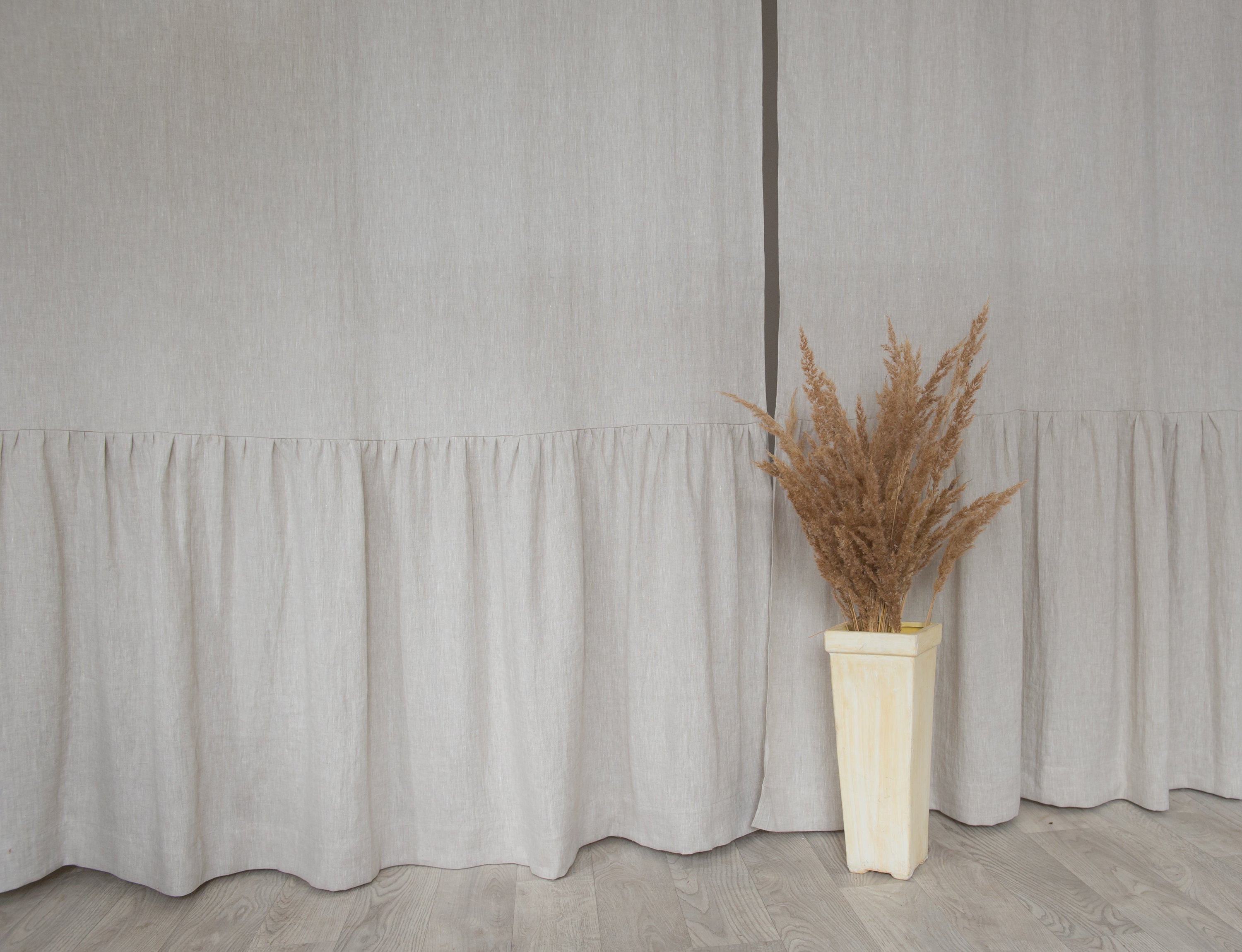 Light Grey linen curtain with ruffles and rod pocket, elegantly draped to showcase its texture and design.