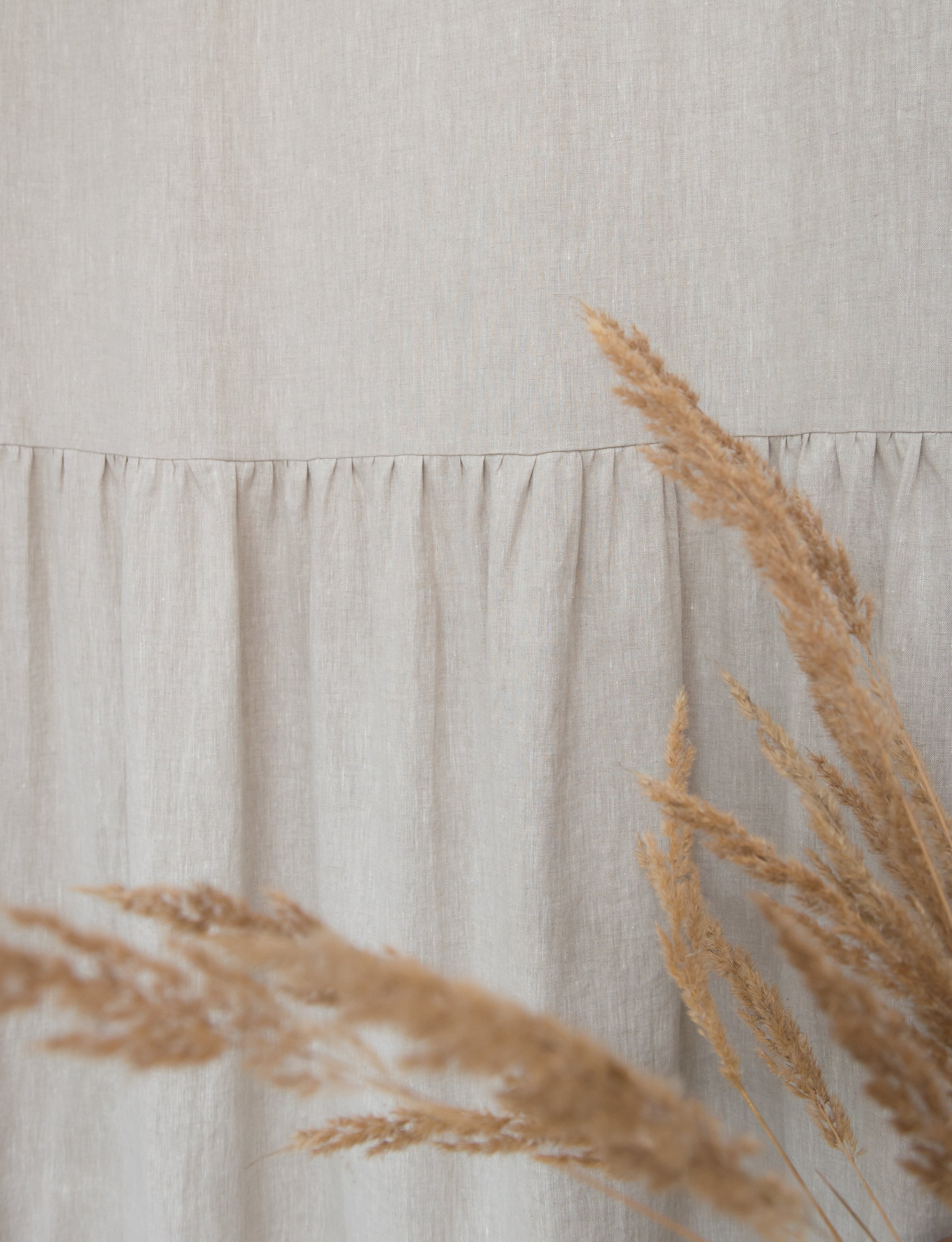 Light Grey linen curtain with ruffles and rod pocket, elegantly draped to showcase its texture and design.