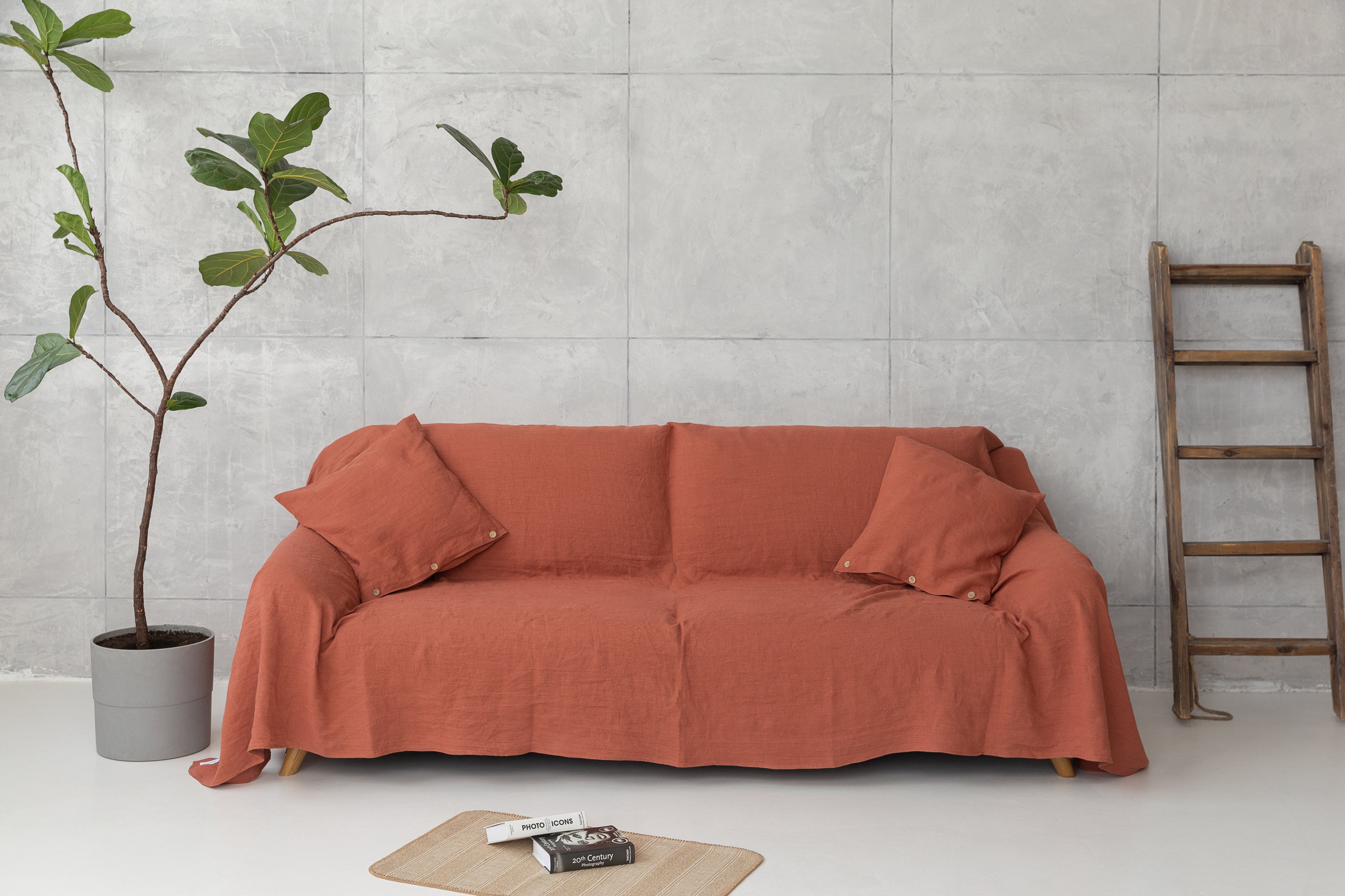 Elegant European linen couch cover draped over a stylish sofa, showcasing its soft texture and natural color variations.