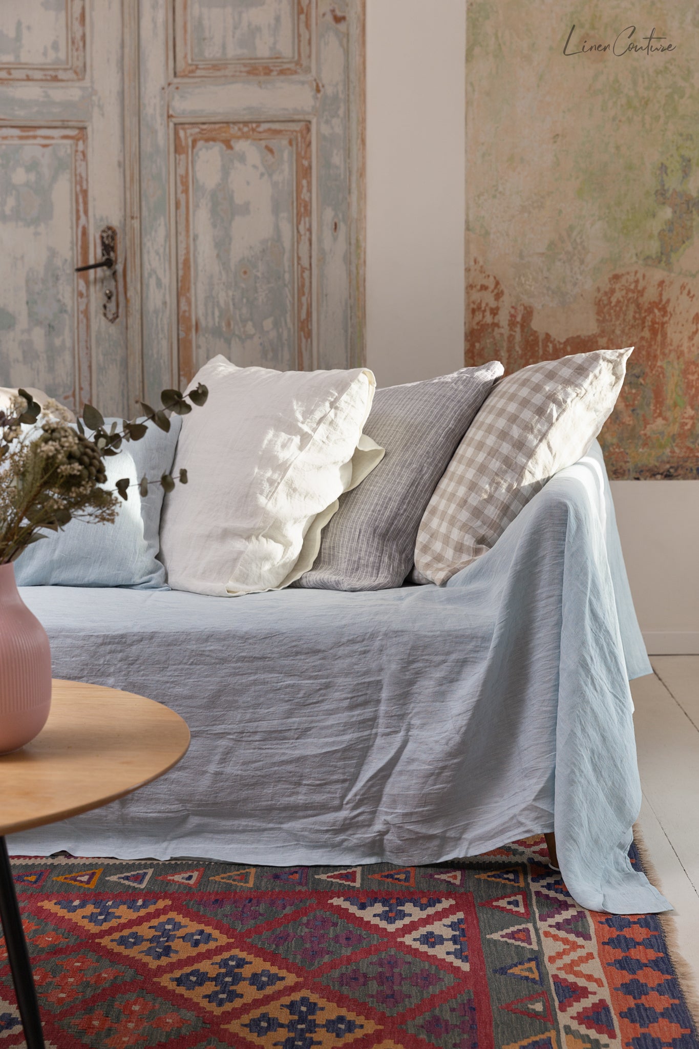 Elegant European linen couch cover draped over a stylish sofa, showcasing its soft texture and natural color variations.