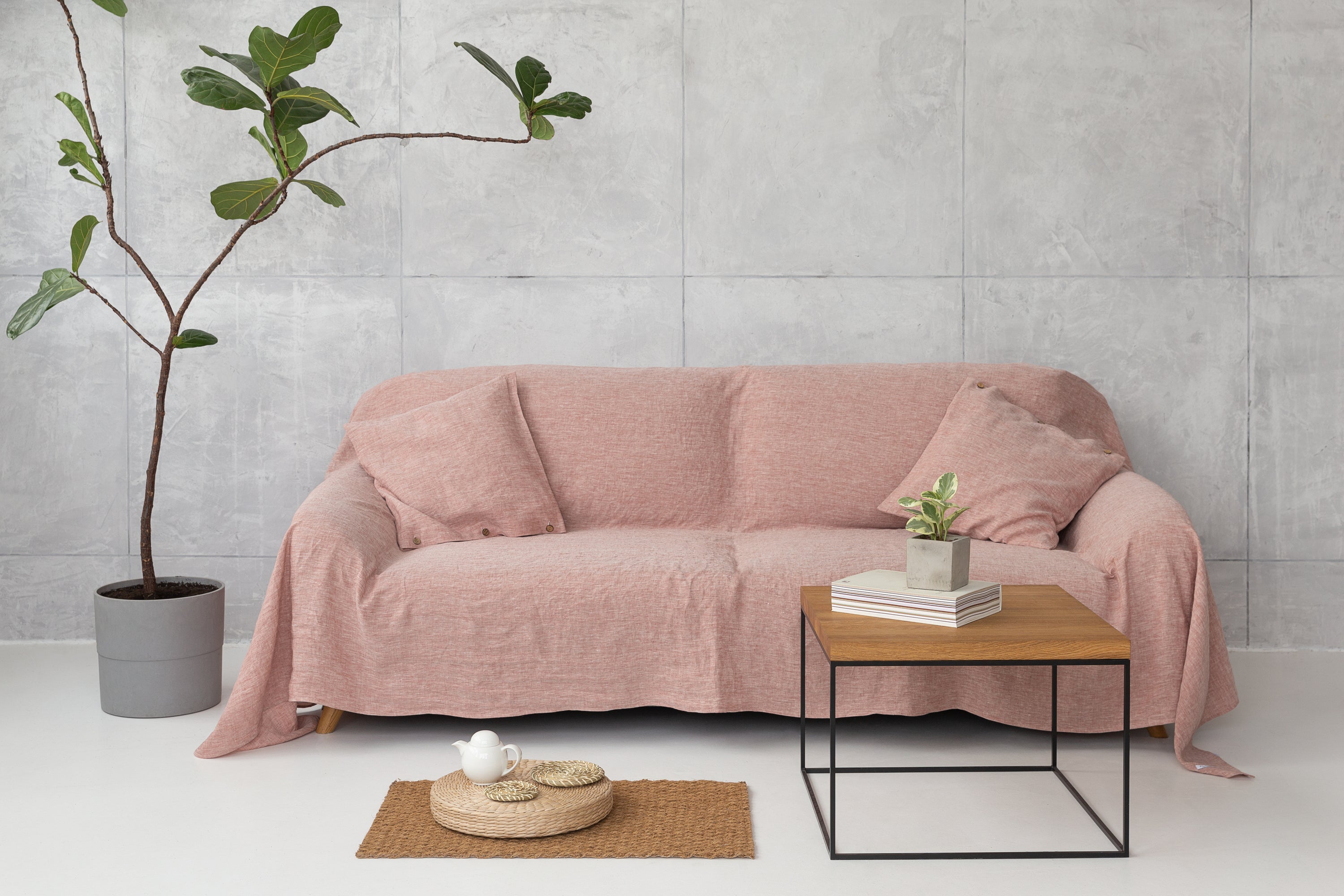 Elegant European linen couch cover draped over a stylish sofa, showcasing its soft texture and natural color variations.