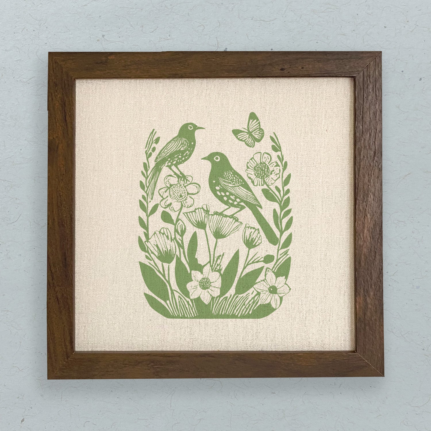 Framed sign featuring Linocut Spring Birds design with a natural wood frame, eco-friendly inks, and a linen-look background.