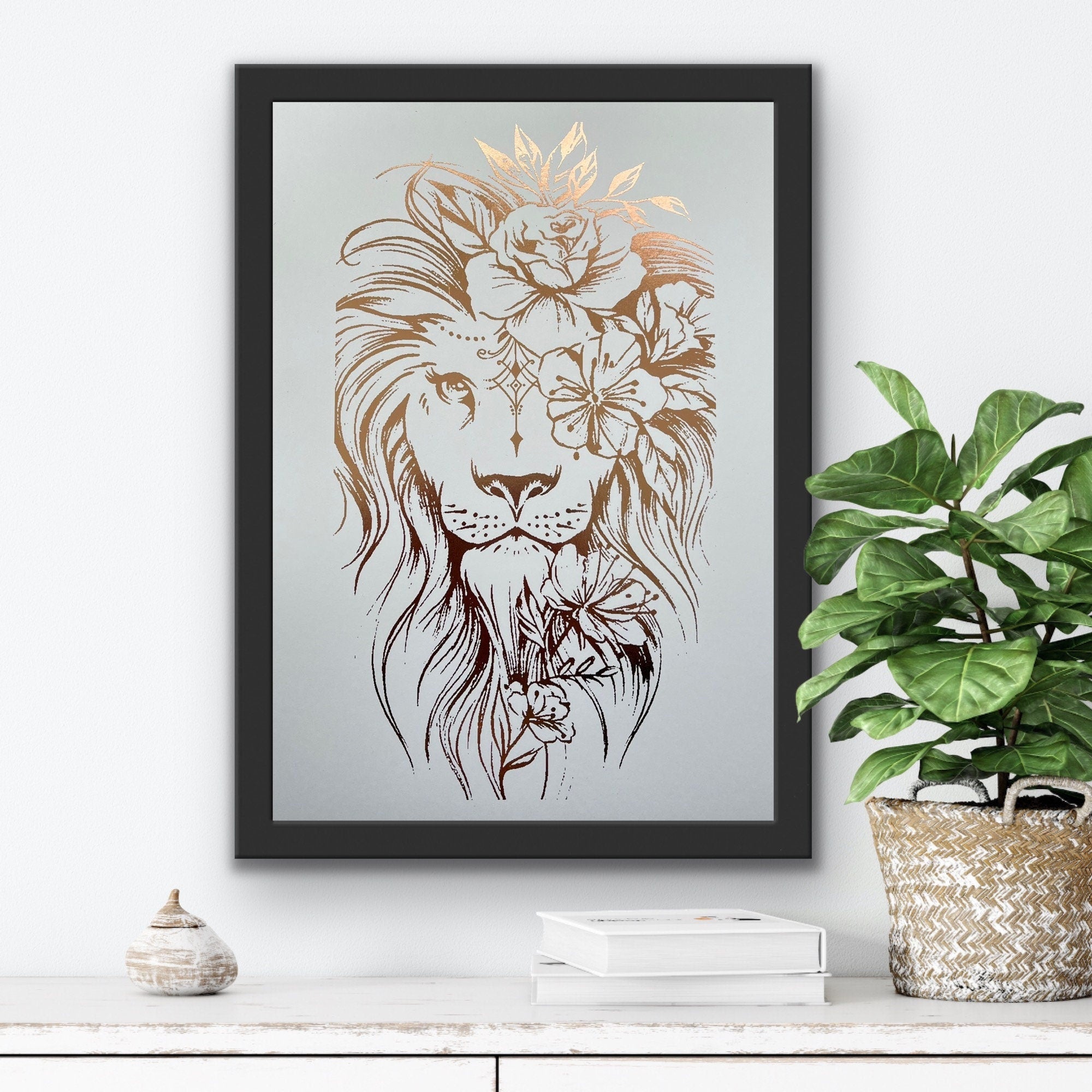 A stunning lion foil print featuring a rose gold lion on a white background, symbolizing courage and strength.