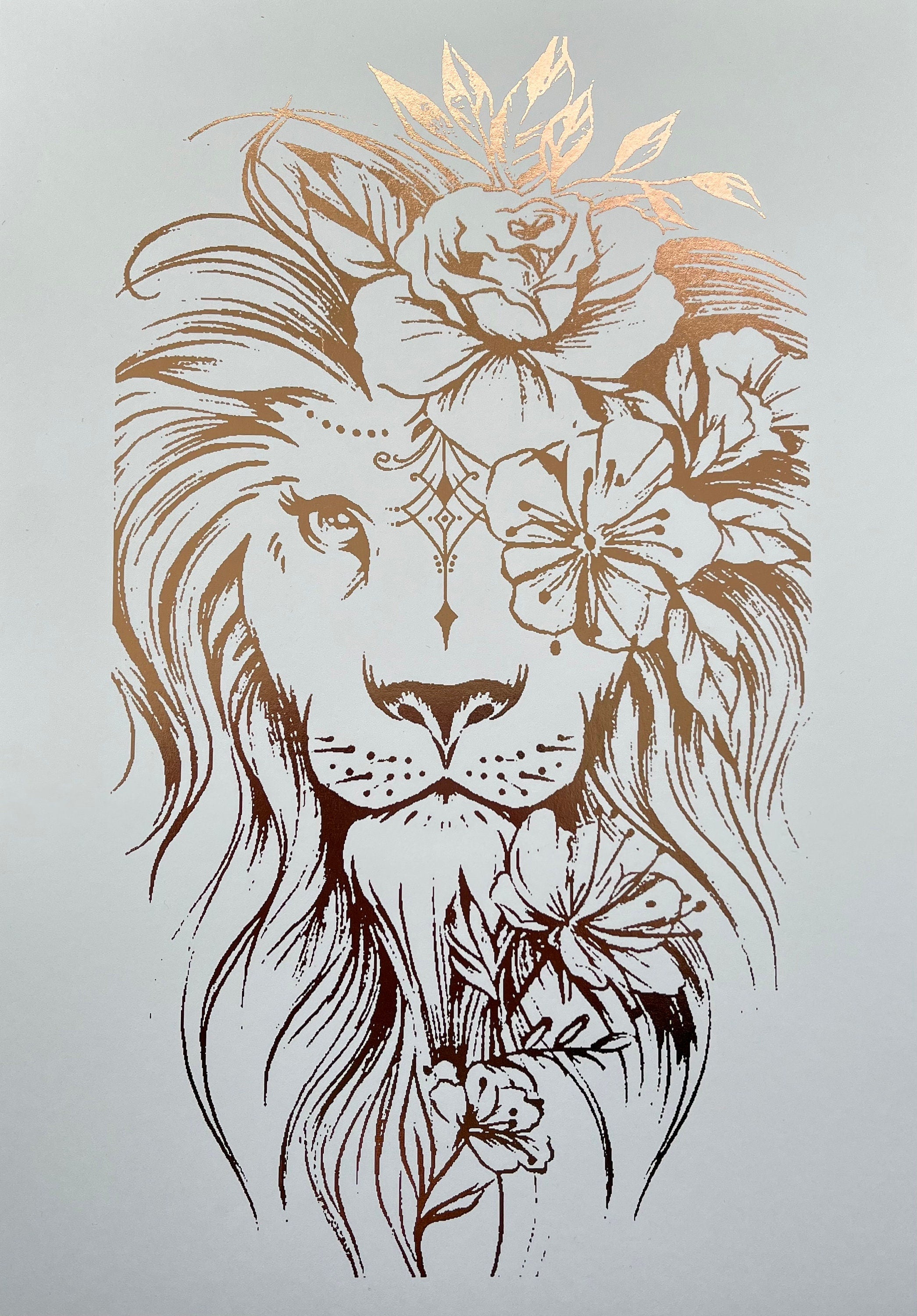 A stunning lion foil print featuring a rose gold lion on a white background, symbolizing courage and strength.