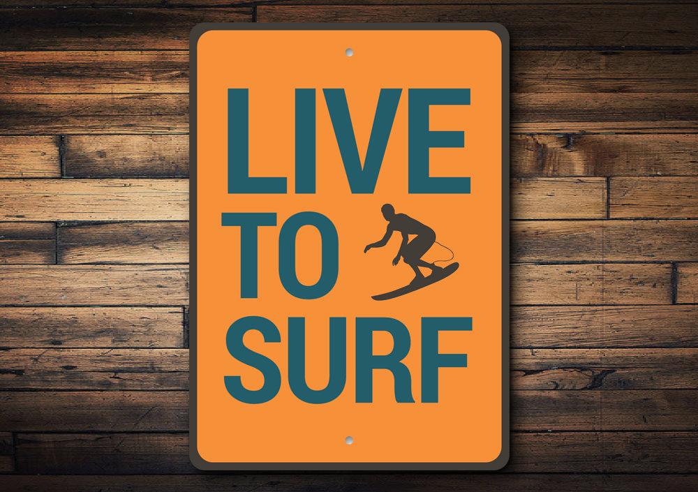 Live to Surf Sign made of high-quality aluminum, featuring a beach-themed design, perfect for coastal decor.