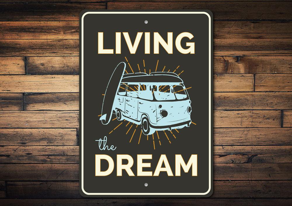 A decorative Living the Dream sign made of high-quality aluminum, featuring a beach-themed design, perfect for coastal decor.