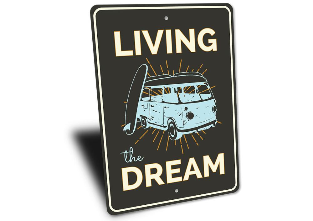 A decorative Living the Dream sign made of high-quality aluminum, featuring a beach-themed design, perfect for coastal decor.