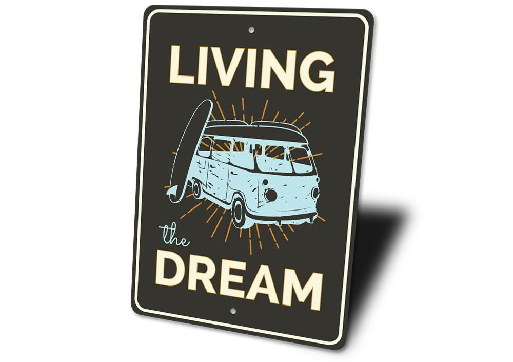 A decorative Living the Dream sign made of high-quality aluminum, featuring a beach-themed design, perfect for coastal decor.