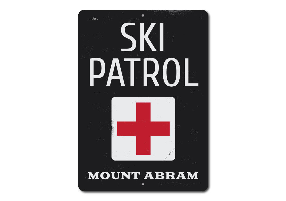 A decorative Location Ski Patrol Sign made of high-quality aluminum, featuring customizable text and pre-drilled holes for easy mounting.