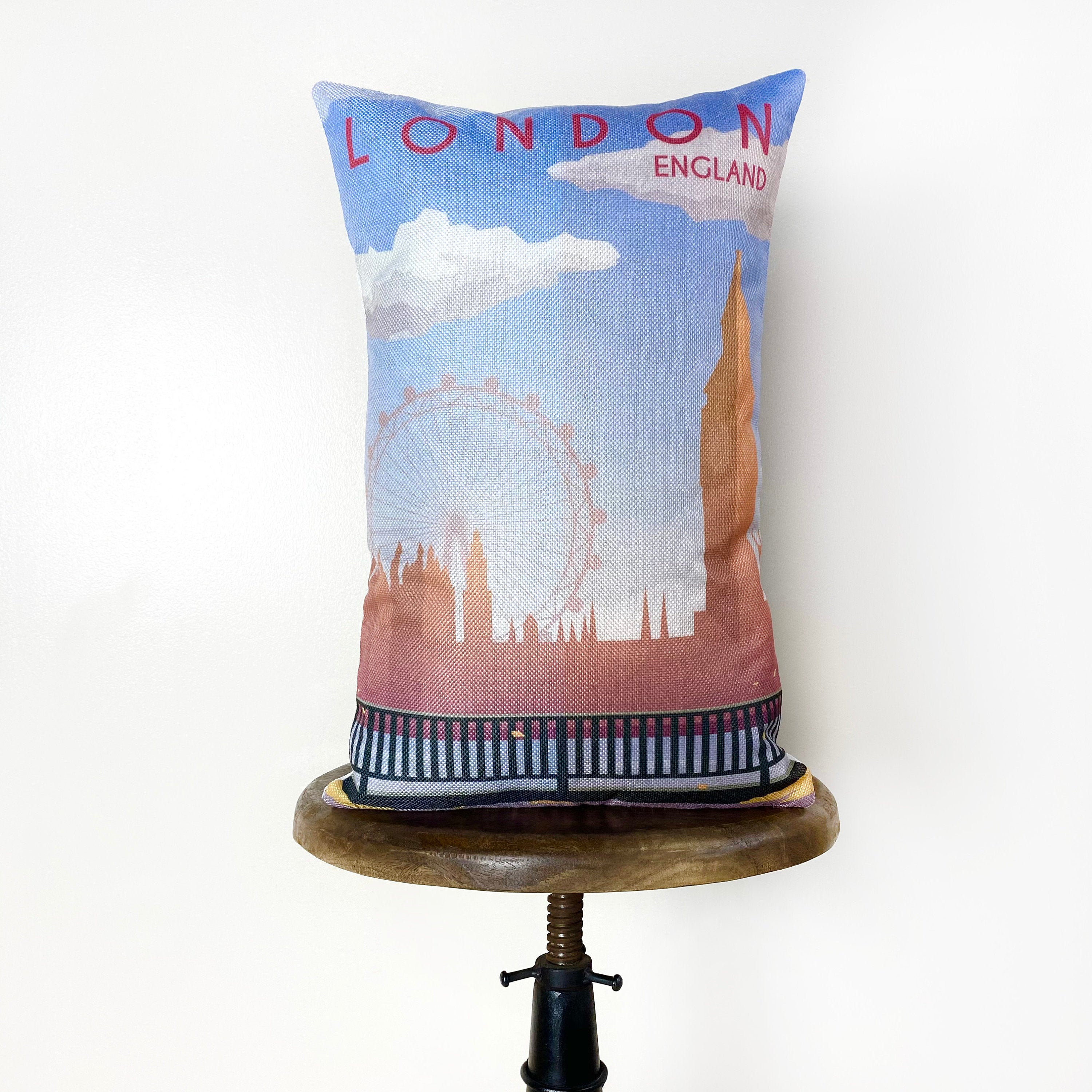 Hand-made 12x18 pillow cover featuring a travel poster design of London, showcasing iconic landmarks like Big Ben and the London Eye.