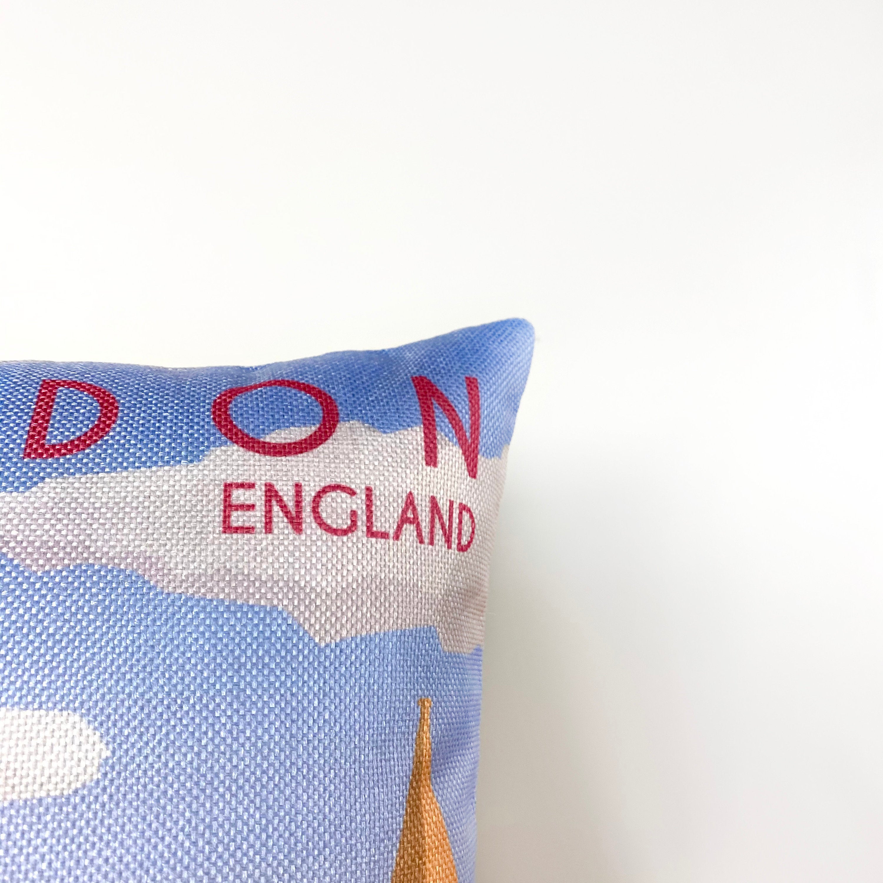 Hand-made 12x18 pillow cover featuring a travel poster design of London, showcasing iconic landmarks like Big Ben and the London Eye.