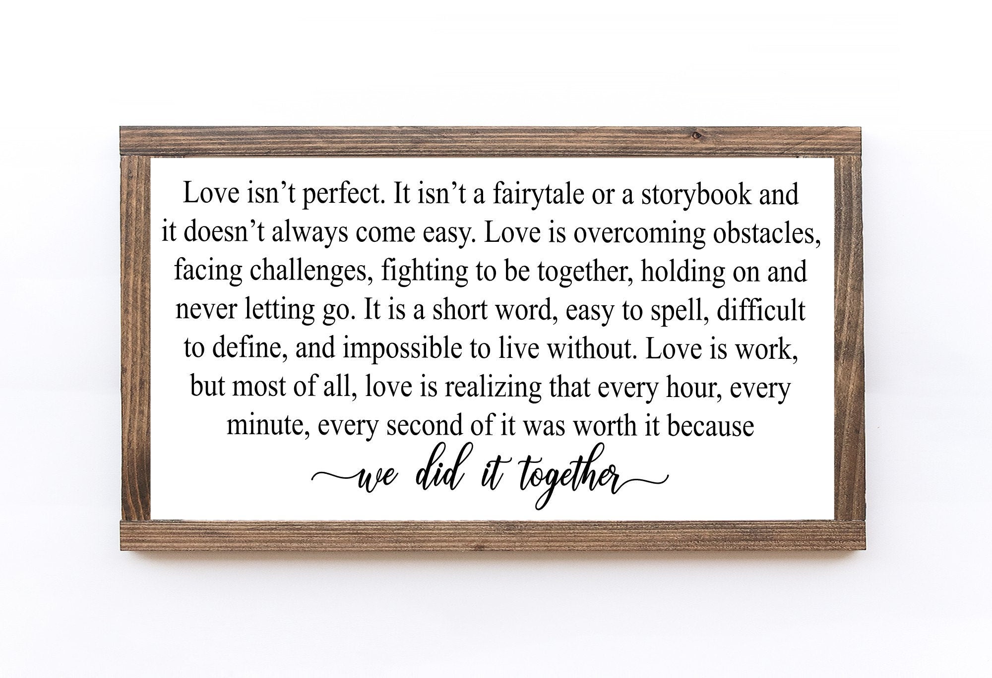 Handmade wooden sign with the phrase 'Love Isn't Perfect It's Overcoming Obstacles' in matte white finish, showcasing unique wood grain.