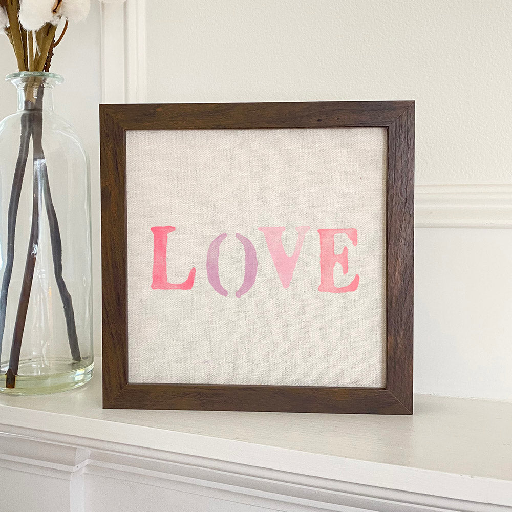 Love Stencil - Framed Sign with a natural linen background and wooden frame options in walnut and white-washed finishes.