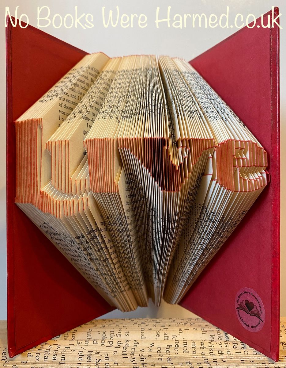 Handcrafted Luve book art made from vintage books, showcasing intricate page folding techniques.