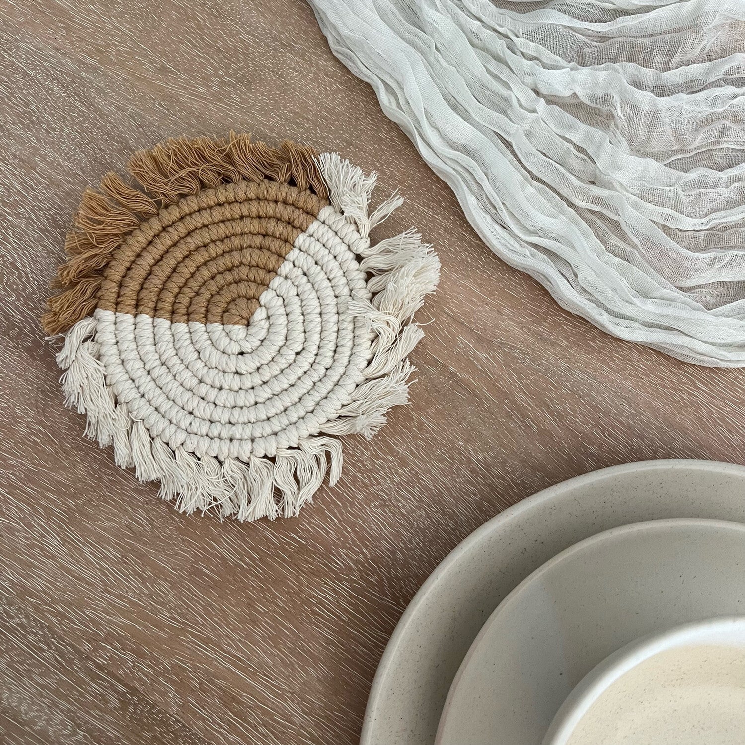 Handwoven macramé drink coaster, 7 inches in diameter, made of cotton cord, showcasing intricate patterns and natural texture.