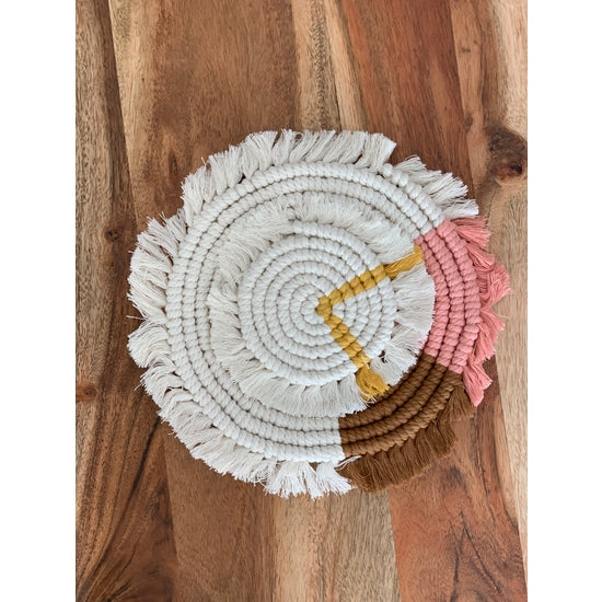 Handwoven macramé drink coaster, 7 inches in diameter, made of cotton cord, showcasing intricate patterns and natural texture.