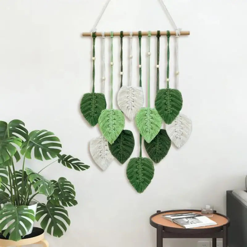 A beautifully handcrafted macrame wall hanging featuring a leaf design, made from soft green cotton rope, perfect for home decor.