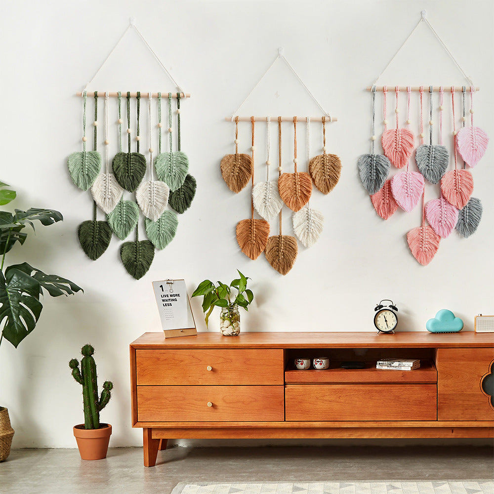 A beautifully handcrafted macrame wall hanging featuring a leaf design, made from soft green cotton rope, perfect for home decor.