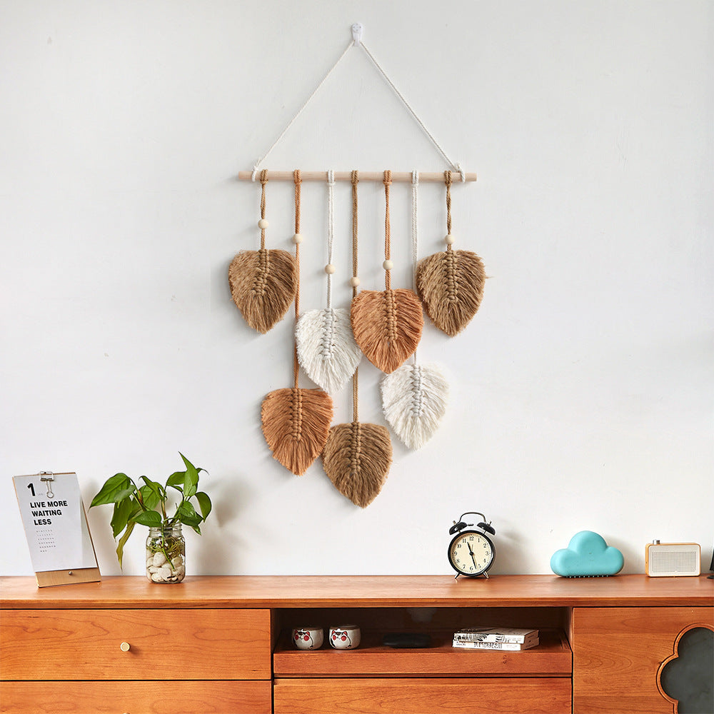 A beautifully handcrafted macrame wall hanging featuring a leaf design, made from soft green cotton rope, perfect for home decor.