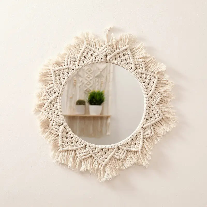 A beautifully crafted round macrame wall mirror wrapped in soft cotton rope, showcasing intricate details and a boho style.