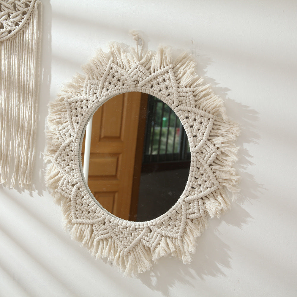 A beautifully crafted round macrame wall mirror wrapped in soft cotton rope, showcasing intricate details and a boho style.