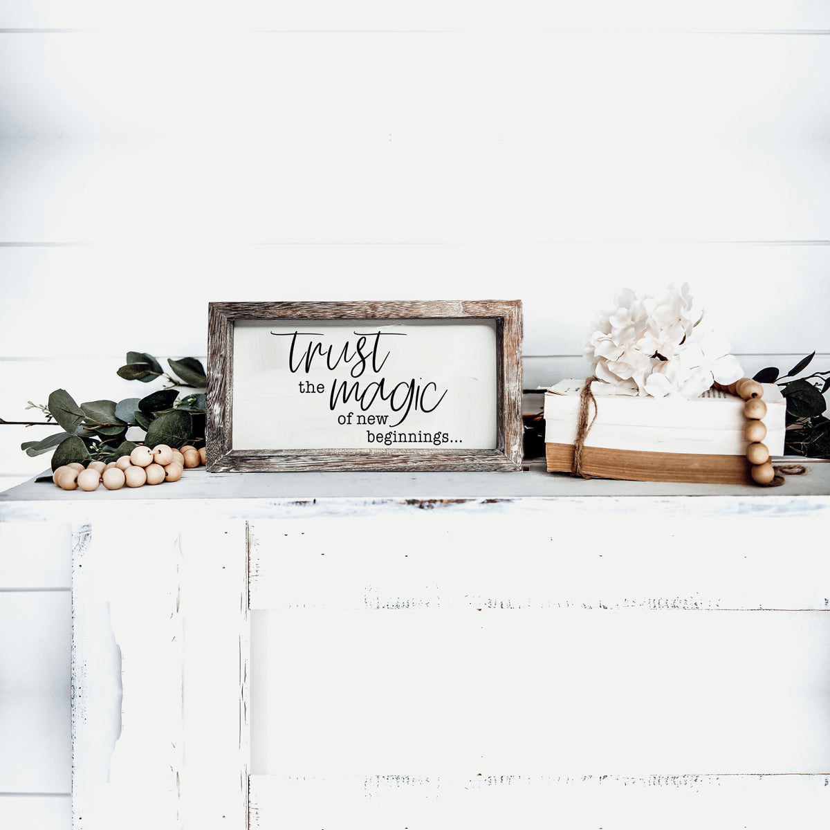 A stylish wooden sign featuring the quote 'Trust in the Magic of New Beginnings', crafted from durable Paulownia wood.