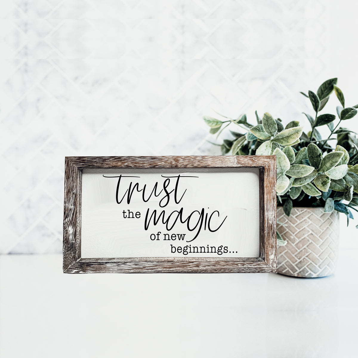 A stylish wooden sign featuring the quote 'Trust in the Magic of New Beginnings', crafted from durable Paulownia wood.