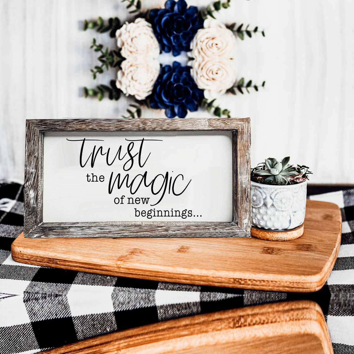 A stylish wooden sign featuring the quote 'Trust in the Magic of New Beginnings', crafted from durable Paulownia wood.